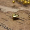 gold heart pin in map